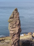 A picture of the old man of stoer sea stack in scotland. A large pillar of rock rising out of the sea.