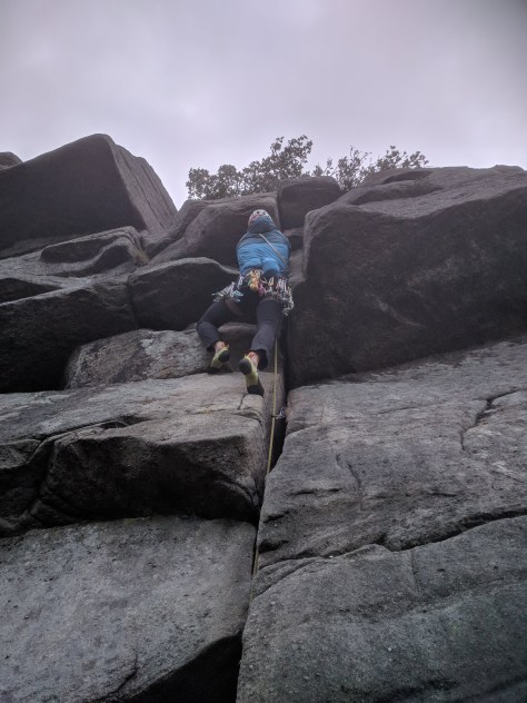 A picture of Jesse climbing Mutiny crack at Burbage North
