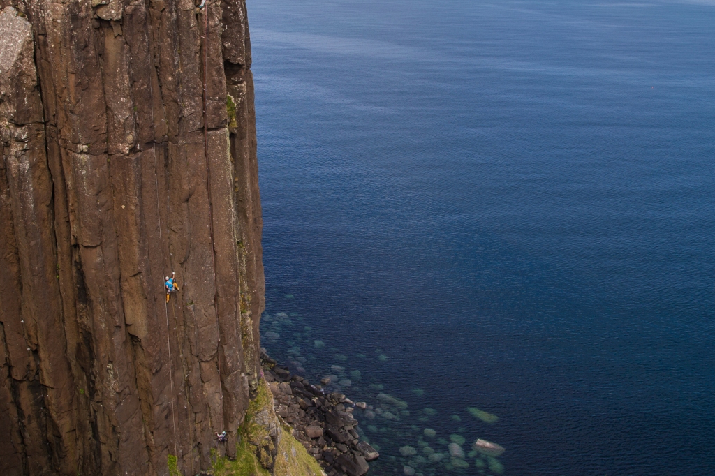 A photo of Jesse leading Grey Panther at Kilt Rock on the Isle of Skye.